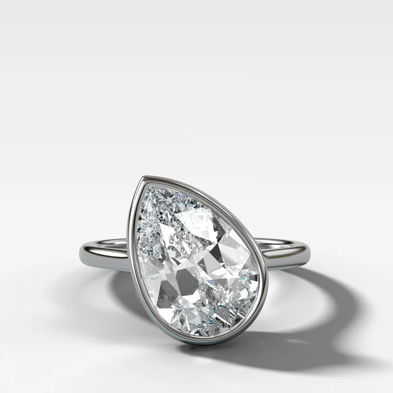 Penumbra Bezel Set Engagement Ring With Tilted Pear Cut