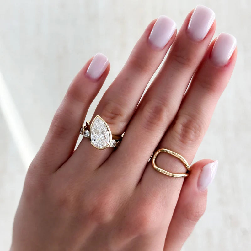 Penumbra Bezel Set Engagement Ring With Tilted Pear Cut