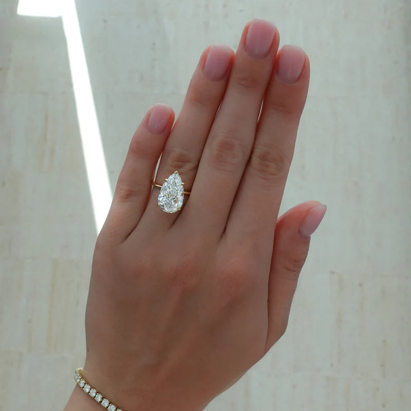 Thin + Simple Solitaire Engagement Ring With Pear Cut Diamond