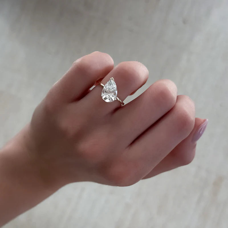Tilted Thin + Simple Solitaire Engagement Ring With Pear Cut Diamond