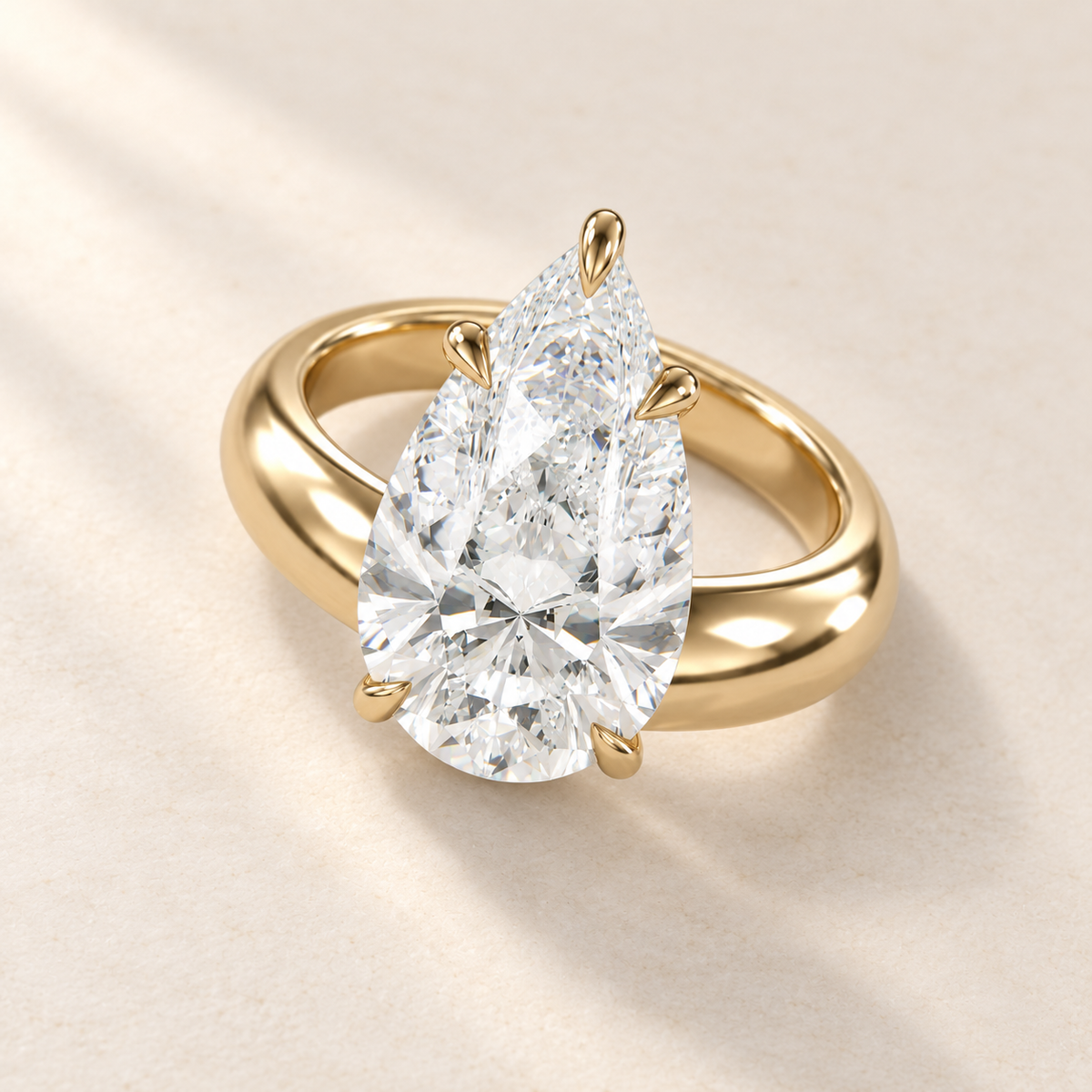 Solara Pear Domed Solitaire Ring in yellow gold, elevated view