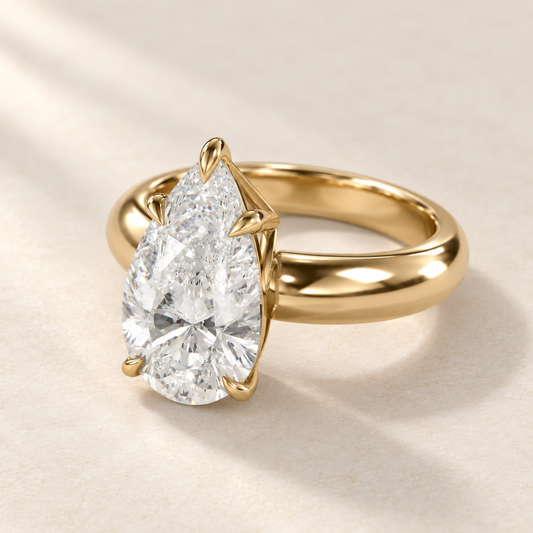 Solara Pear Domed Solitaire Ring in yellow gold, three-quarter view