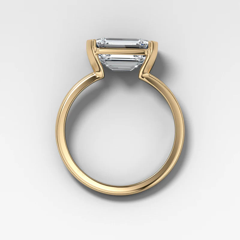 East West Half Bezel Solitaire Engagement Ring With Emerald Cut Diamond