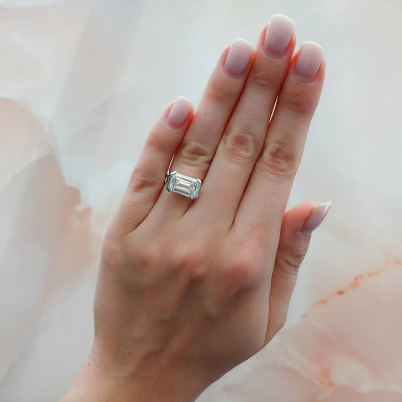 East West Half Bezel Solitaire Engagement Ring With Emerald Cut Diamond