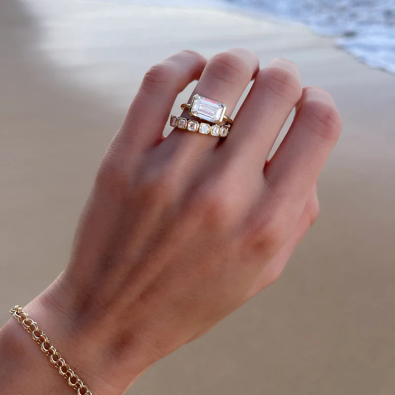 East West Half Bezel Solitaire Engagement Ring With Emerald Cut Diamond