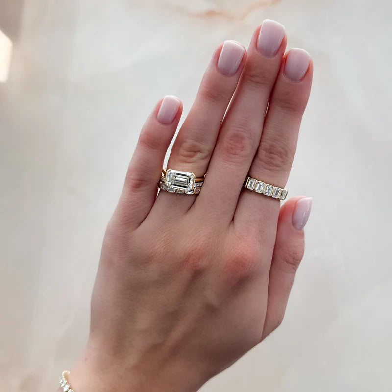 East West Half Bezel Solitaire Engagement Ring With Emerald Cut Diamond