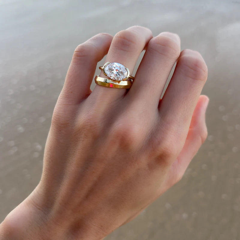 East West Half Bezel Solitaire Engagement Ring With Oval Cut Diamond