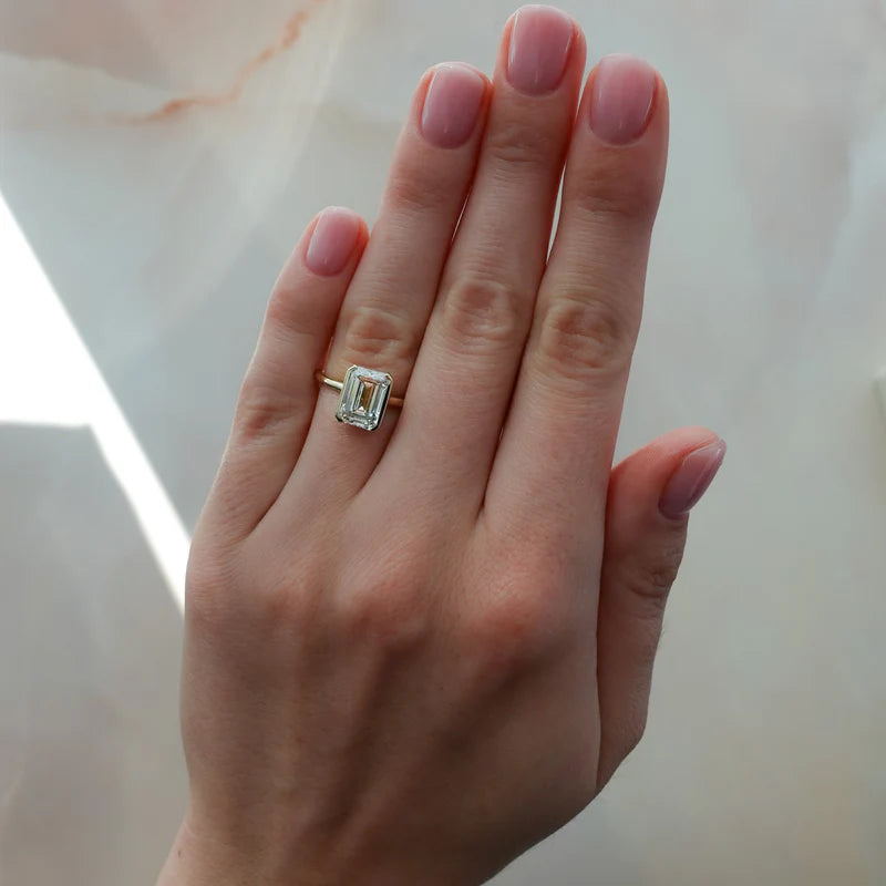 North South Half Bezel Solitaire Engagement Ring With Emerald Cut Diamond
