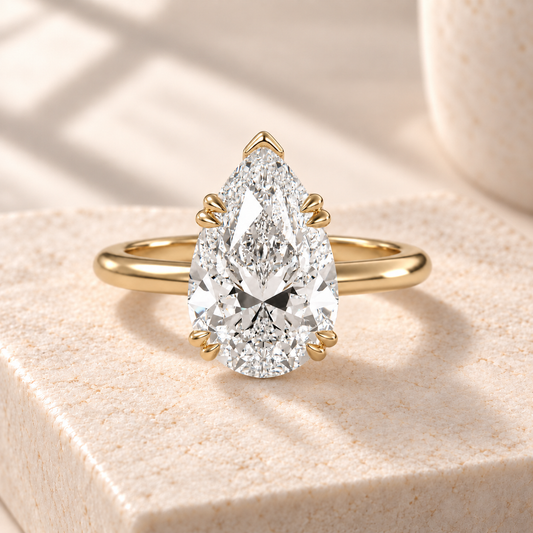 Altara Pear Cathedral Ring in yellow gold on cream stone, front view