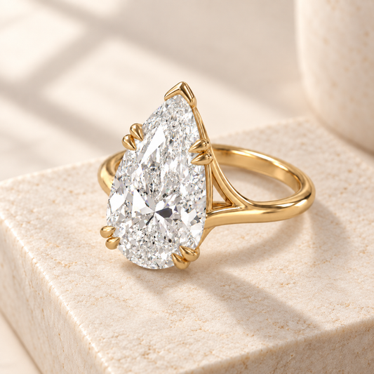 Altara Pear Cathedral Ring in yellow gold on cream stone, three quarter view