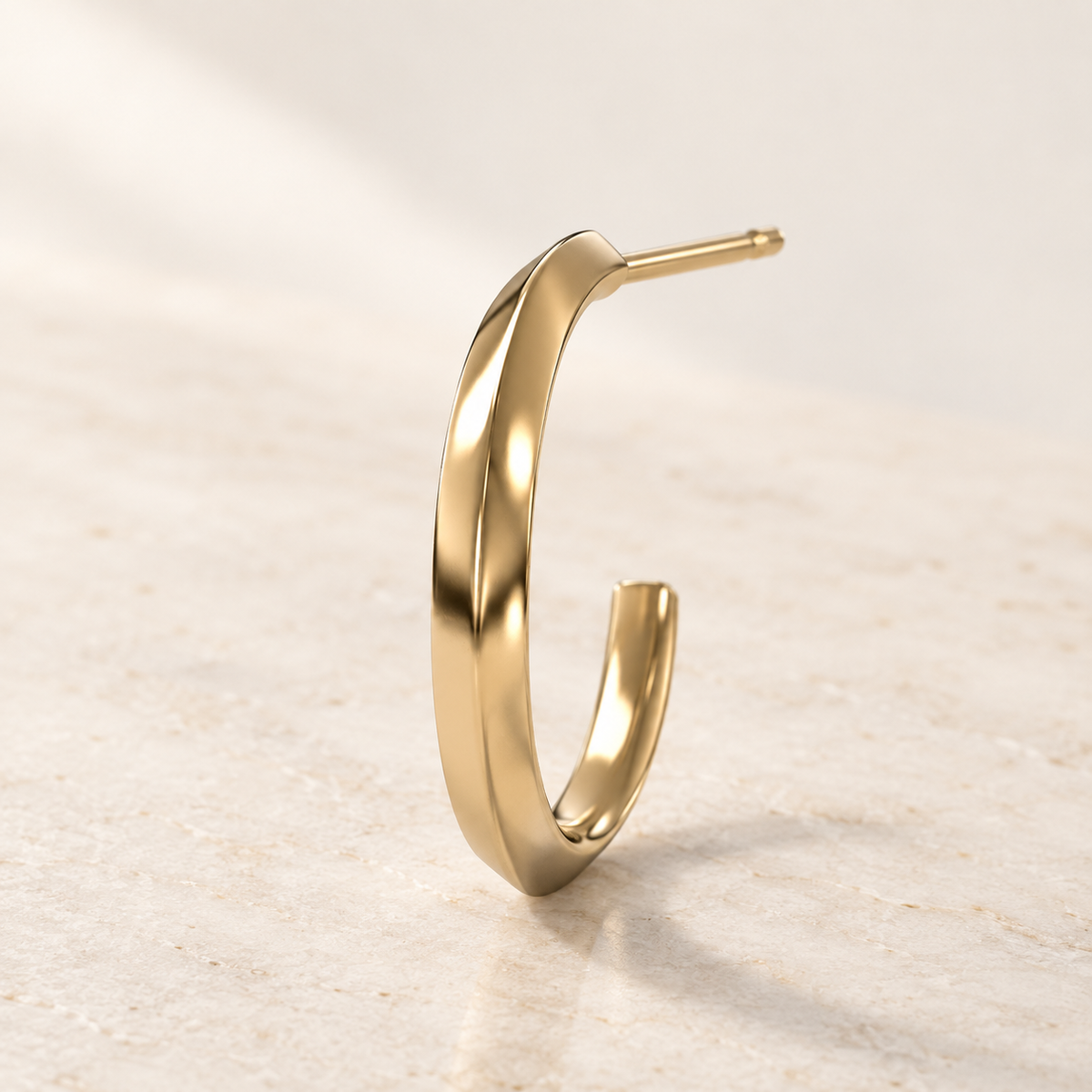 AI product preview of one Astra Knife-Edge Hoop Earring in yellow gold, three-quarter view