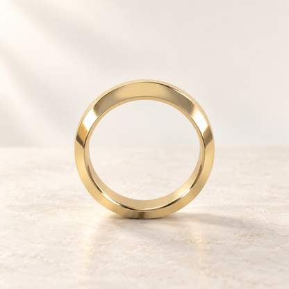 AI product preview of Astra Wide Knife-Edge Wedding Band in yellow gold, front view