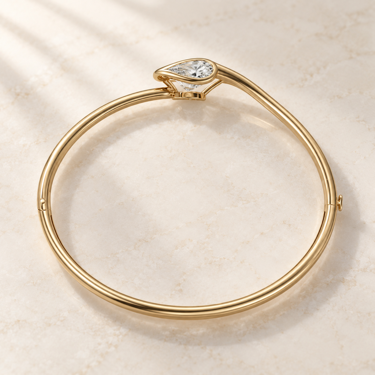 AI product preview of Embrace East-West Pear Diamond Bangle in yellow gold, elevated rear view