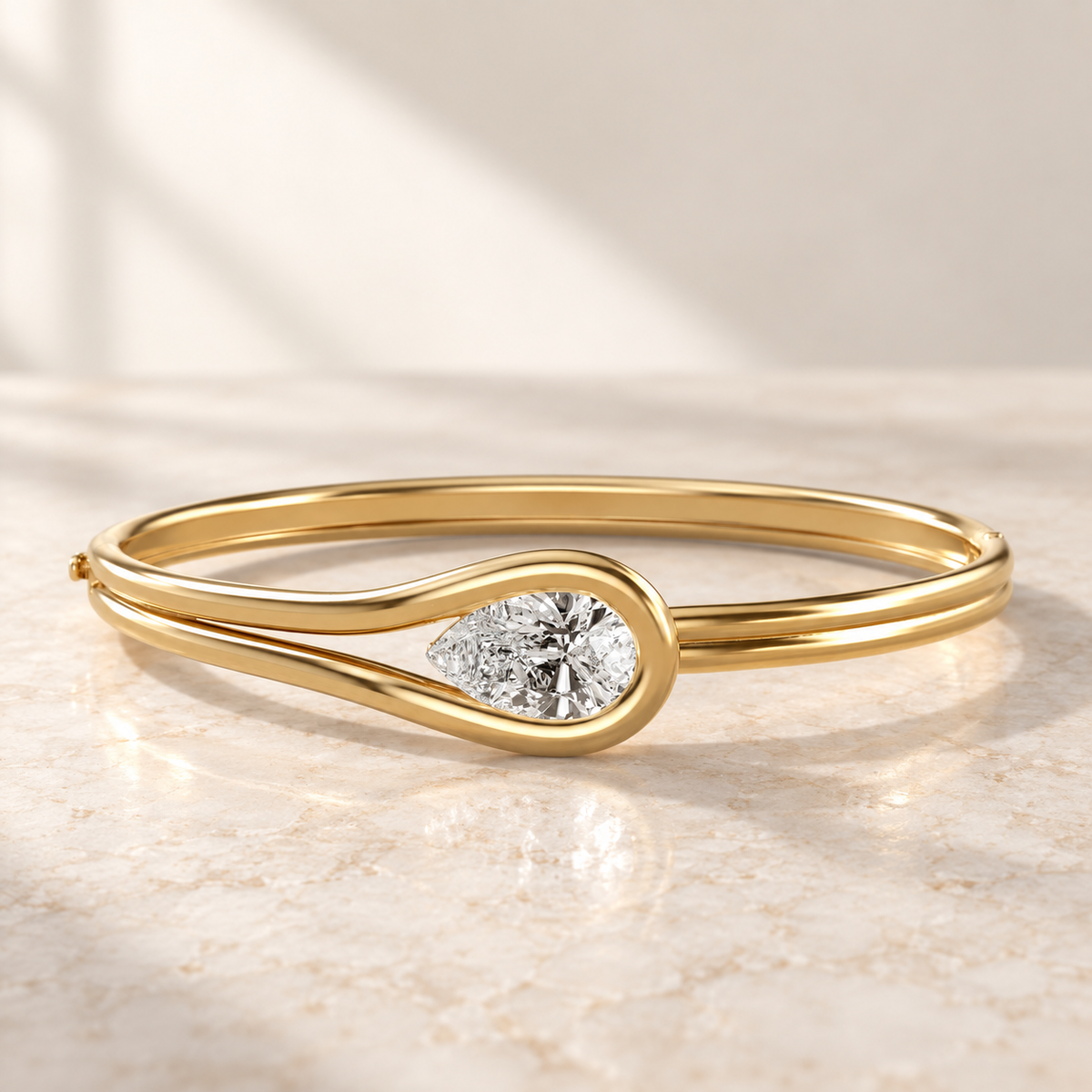 AI product preview of Embrace East-West Pear Diamond Bangle in yellow gold, low front view