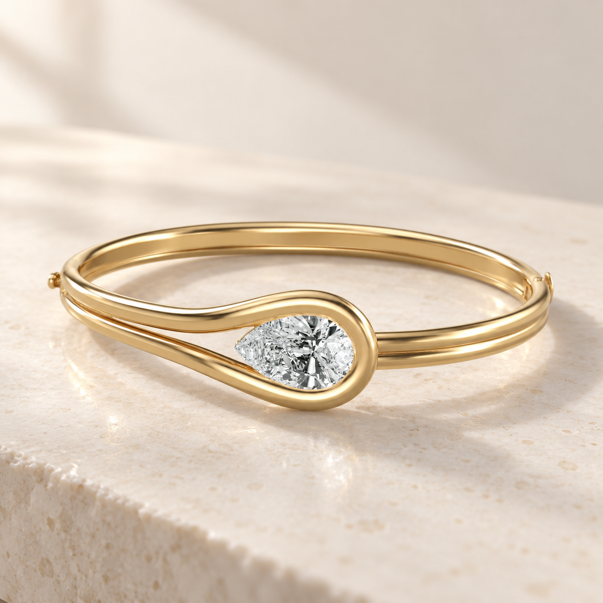 AI product preview of Embrace East-West Pear Diamond Bangle in yellow gold, elevated front view