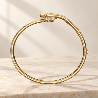 AI product preview of Embrace Tilted Pear Diamond Bangle in yellow gold, structural side profile