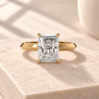 Veyra elongated radiant lab-grown diamond solitaire with a knife-edge yellow gold band, front design preview