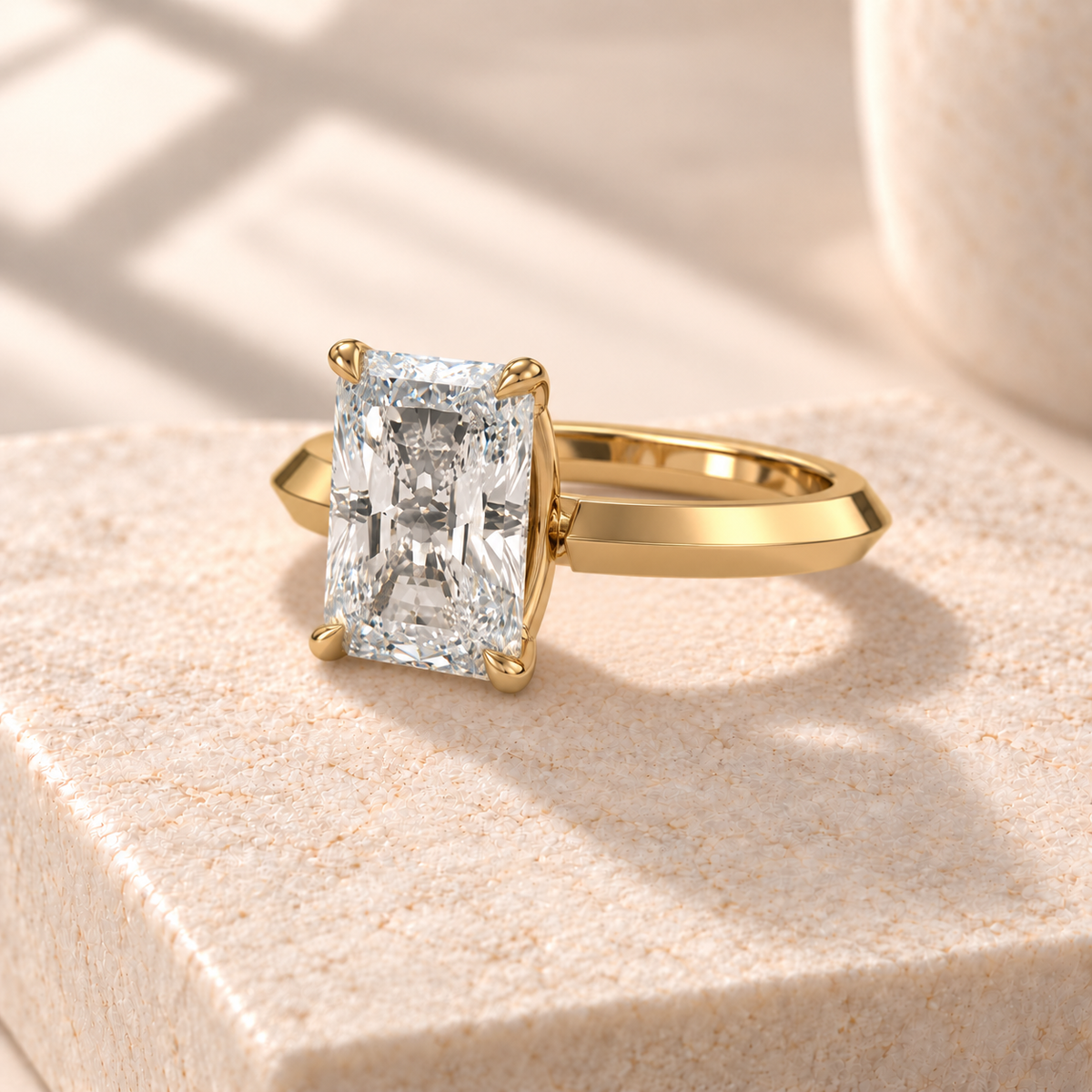 Veyra elongated radiant lab-grown diamond solitaire with a knife-edge yellow gold band, three-quarter design preview