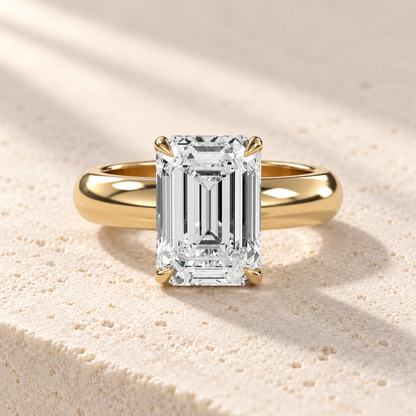 Solara Emerald Domed Solitaire Ring in yellow gold, front view — AI design preview
