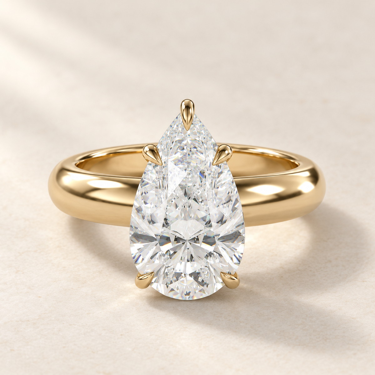 Solara Pear Domed Solitaire Ring in yellow gold, front view