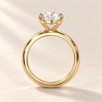 Solara Pear Domed Solitaire Ring in yellow gold, basket profile
