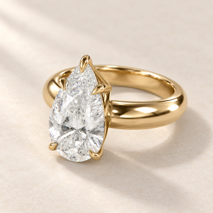 Solara Pear Domed Solitaire Ring in yellow gold, three-quarter view